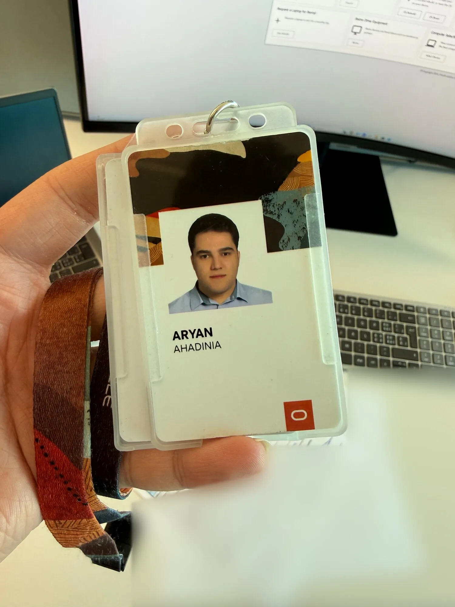 Holding my Oracle badge at my desk